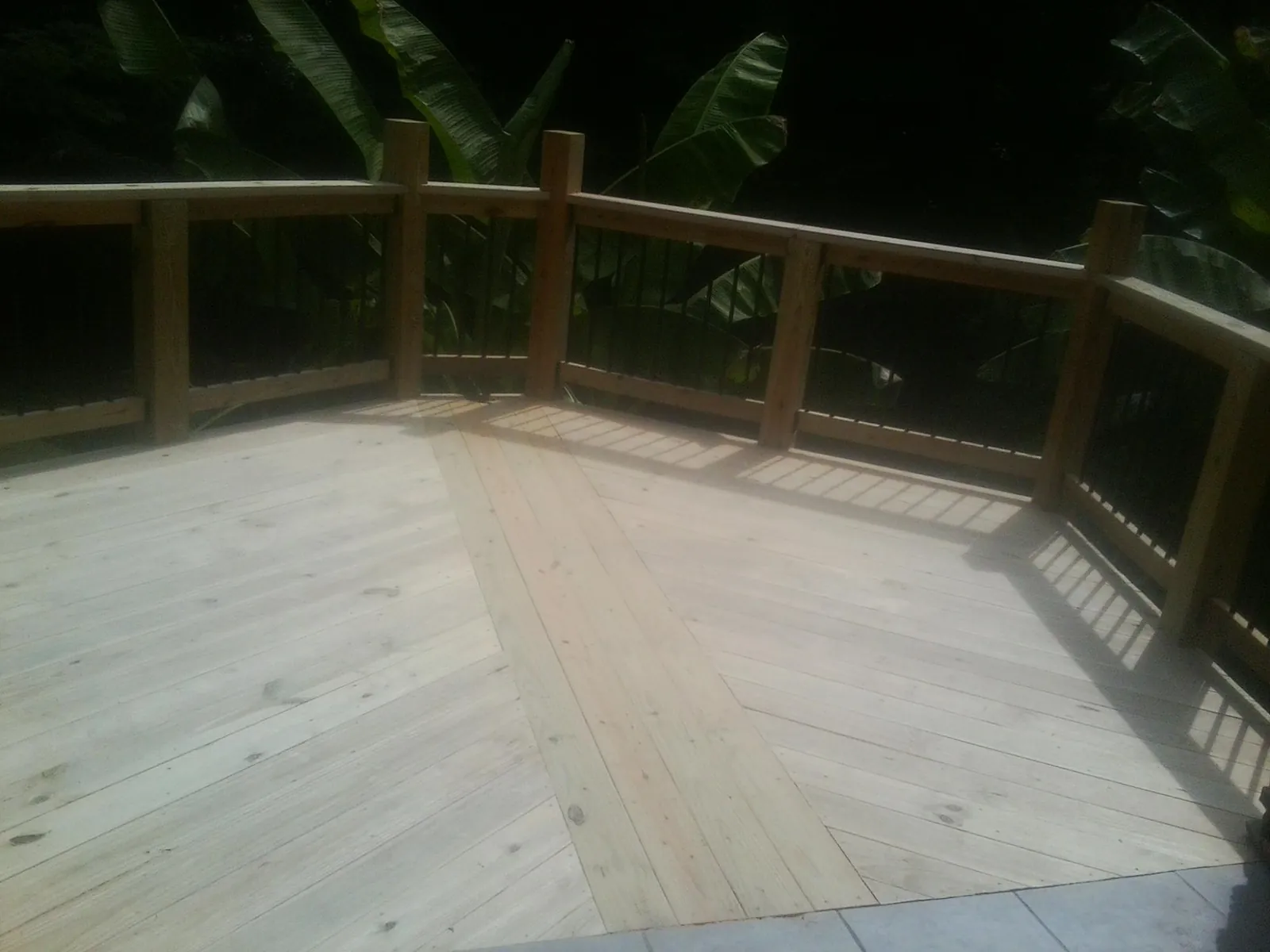 New wood deck and railing built off the back of a home in Agency